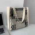 Close-up of cream canvas tote bag featuring ABLE text and geometric stripe pattern - Geometric Beige