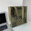 Detail view of army green canvas tote bag with black geometric stripes and wide strap - Geometric Army Green