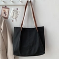 Close-up of minimalist black nylon tote bag with brown faux leather shoulder straps - No Pendant / Black