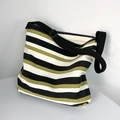 Detail of large striped canvas tote bag showing thick fabric and adjustable strap - Black Striped Bag (Black/White/Olive Green)