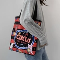 Close-up of canvas tote bag featuring red and black circus pattern with cartoon rabbit - Circus Acrobat Black