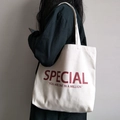 Détail d'un sac cabas en toile minimaliste avec texte Special rouge sur tissu blanc - Blanc Cassé