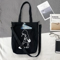 Detail of black canvas tote bag with minimalist cartoon illustration and front pocket - Intoxicated Girl Black Multi-use