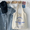 Detail of cream canvas tote bag featuring blue cartoon bear print and long shoulder straps - Cute Bear Beige Vest Style