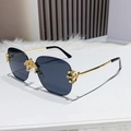 Frameless square sunglasses with dark grey lenses and ornate gold embossed metal details - Solid Grey