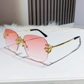 Rimless square sunglasses featuring pink gradient lenses and ornate gold metal arms - Dual-tone Pink
