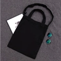 Versatile black canvas tote bag with adjustable shoulder strap and spacious interior - Black Dual-Use Bag with Zipper