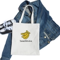 Minimalist white canvas tote bag with banana print and Sweetbanana script lettering - White Banana