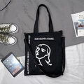 Vue détaillée du sac cabas en toile noire avec portrait artistique de style Matisse - Art Linéaire Femme Noir (Double Usage)