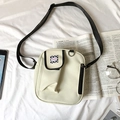 Detail of a beige canvas crossbody bag with Fashion label on a white fabric background - Off White