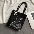 Detail of black canvas tote bag with rabbit print and cute panda plush pendant - Rabbit Print (With Panda Charm) / Black