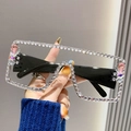Oversized square sunglasses with rhinestones and pink gems held by a person - Transparent