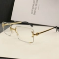 Classic rimless rectangular sunglasses with gold metal temples and textured bridge - Clear