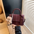 Fashionable burgundy suede crossbody bag with white stitching and plush dog charm - With Charm / Burgundy