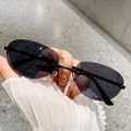 Chic rimless oval sunglasses with smoke gray lenses and slim black temples in hand - Solid Grey