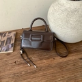 Detail of vintage dark brown faux leather square handbag with heart pendant on rustic wood - Coffee with Pendant