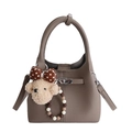 Taupe lychee leather bucket bag with ring handle and plush bear pendant detail - With Pendant / Gray