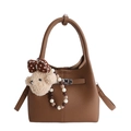 Brown litchi-grain leather bucket bag featuring a plush bear charm and beaded accent - With Pendant / Brown