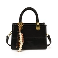 Black leather crossbody bag with woven handle and bohemian beaded tassel accent - Black
