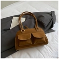 Close-up of vintage brown leather pillow bag with dual pockets on grey blazer - Brown No Pendant