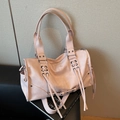 Light pink faux leather hobo bag featuring silver rivets and trendy long tassels - Pink