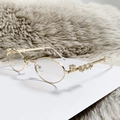Y2K vintage oval sunglasses with gold metal frame and rhinestone cross details - Gold Frame Light Tea Lens