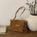 Detail of tan suede shoulder bag featuring a metal twist lock and a cute bear charm - With Charm / Brown