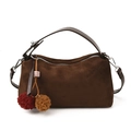 Dunkelbraune Wildleder-Handtasche mit Lederriemen und bunten Anhängern auf weißem Hintergrund - Mit Anhänger / Braun