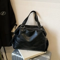 Grande borsa tote nera minimalista con anelli metallici su una valigia d'argento - Nero senza Ciondolo
