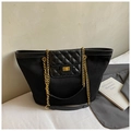 Detail of black canvas tote featuring quilted leather flap and golden chain straps - Black (Without Charm)