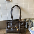 Détail du sac à bandoulière en similicuir marron avec texture vintage et boucle dorée - Marron
