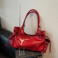 Glossy red faux leather shoulder bag with side drawstring details and long handles - Red