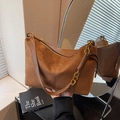 Brown suede crossbody bag featuring retro hobo design with leather woven details - Brown