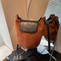 Bolso tipo cubo vintage de ante marrón con solapa de cuero negro y correa fina - Marrón