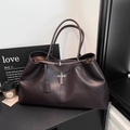 Detail view of deep brown leather tote bag with vintage silver cross and chain accent - Brown