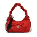 Red suede crescent bag featuring a bow, heart pendant, and unique ruched handle design - Red