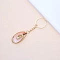 Pink shell keychain with gold metallic edges and golden ring on a minimalist background - 23# (Pink Orange Spiral Conch)