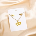 Golden double interlocking heart necklace and stud earrings set on satin background - Classic Interlocking Hearts Style