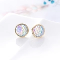 Macro shot of iridescent mermaid fish scale studs in a polished gold round frame - K5 / White