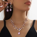 Golden bridal jewelry set with purple rhinestones and waterdrop gems on elegant model - 2-Piece Set(GT25232) / Purple