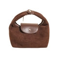 Detail view of dark brown handbag showing suede and smooth leather texture with silver zipper - Brown