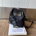 Black ruched crescent bag with silver studs and decorative leather bow detail - Black