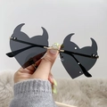 Unique black rimless devil heart sunglasses with golden metal frame held by hand - Gold Frame Black Grey