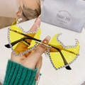 Frameless flame sunglasses with yellow lenses and white rhinestones in hand - Gold Frame Yellow Lenses