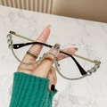 Lunettes de soleil sans monture à bord ondulé avec strass brillants et branches dorées - Strass Blancs Verres Transparents