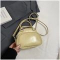 Beige pillow bag with baseball stitch detail and detachable strap in a minimal setting - No Pendant / Yellow