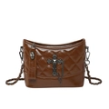 Caramel brown quilted crossbody bag with metal cross and chain strap on white background - Brown