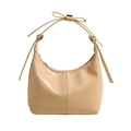 Detail of cream hobo bag featuring vertical stitching and a unique leather bow handle - Light Yellow