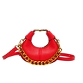 Red pebbled leather half-moon handbag featuring a bold gold chain and adjustable strap - Red