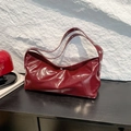 Chic burgundy leather pillow bag with silver studs and polished shoulder strap - Red